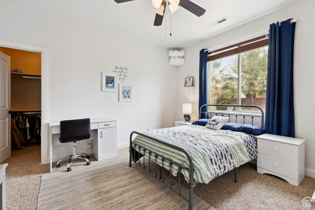Bedroom featuring visible vents, a closet, baseboards, a spacious closet, and a ceiling fan