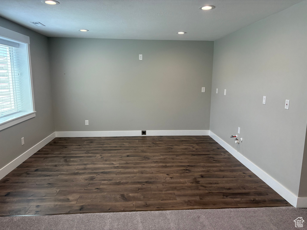 Unfurnished room featuring recessed lighting and dark wood-style flooring