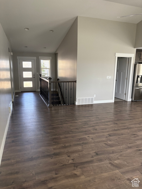 Entryway with vaulted ceiling, dark wood-style flooring, and recessed lighting