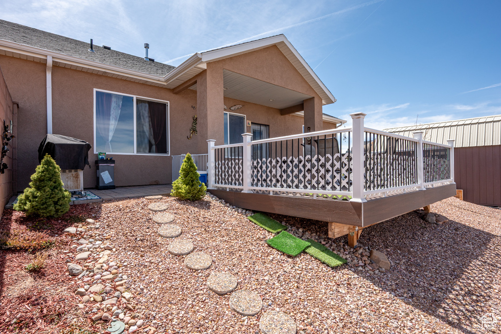 Rear view of property featuring stucco siding