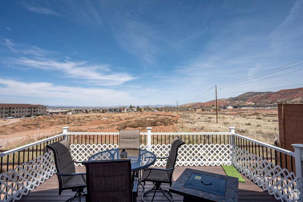 Wooden deck featuring outdoor dining area and a mountain view