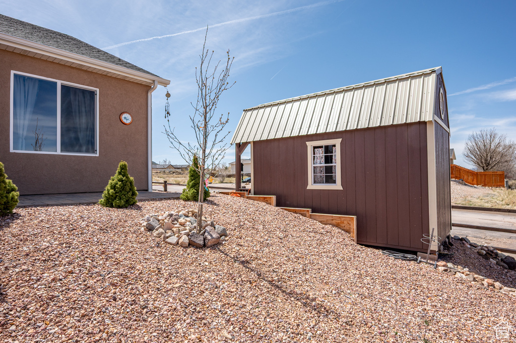 View of side of property with an outdoor structure