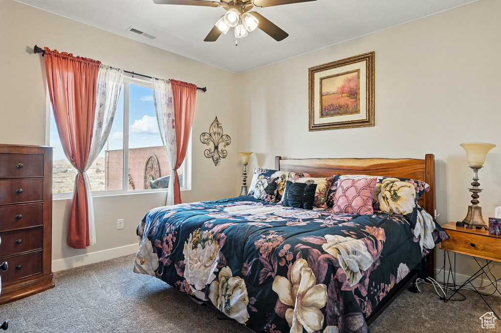 Bedroom featuring carpet flooring, visible vents, baseboards, and ceiling fan