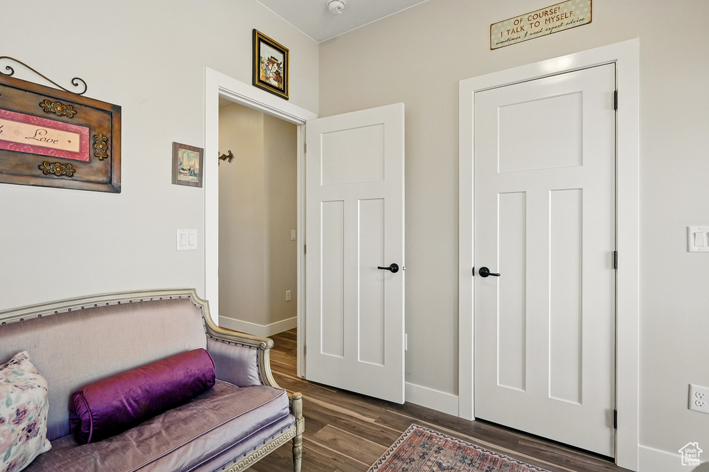 Living area with wood finished floors and baseboards