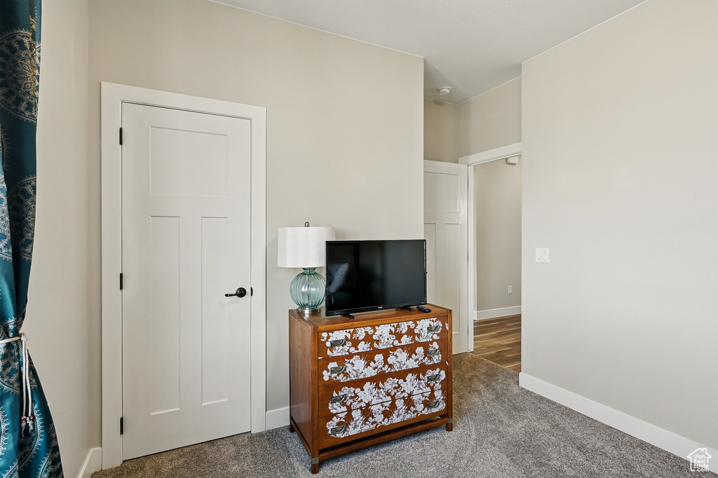 Interior space with carpet flooring and baseboards