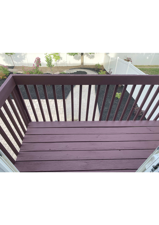 Wooden deck with a fenced backyard