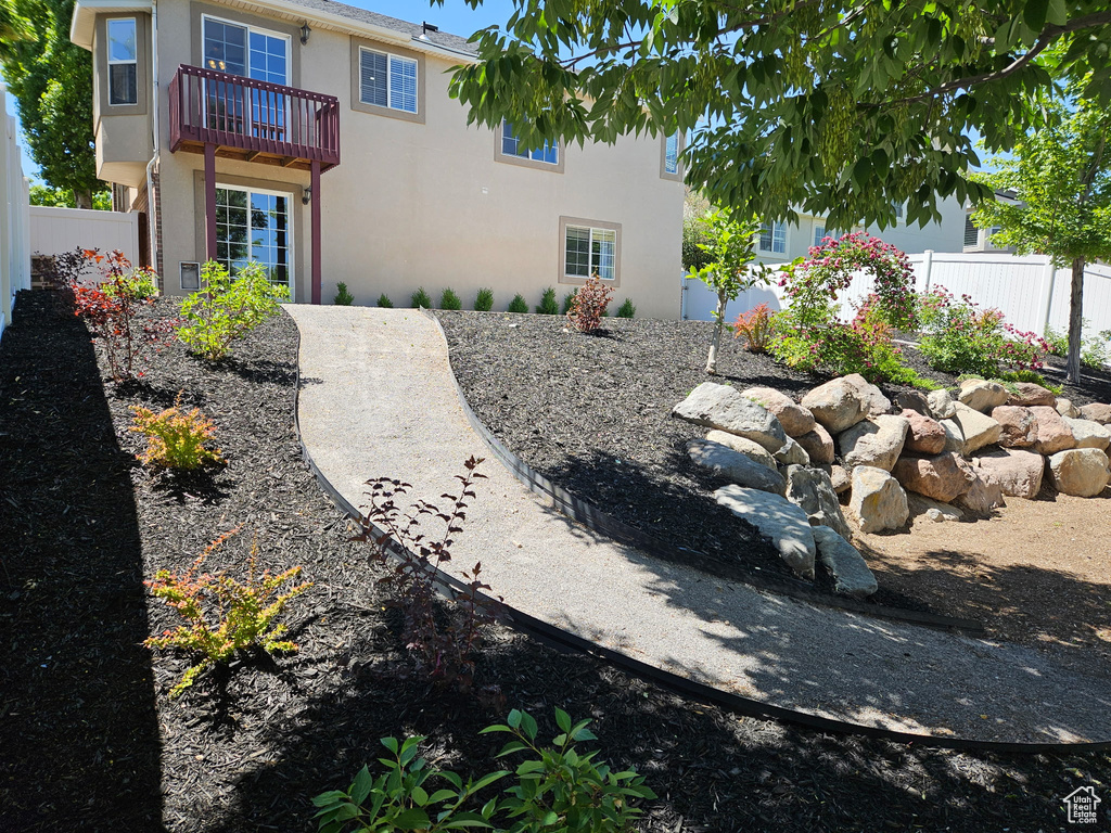 View of yard featuring a balcony