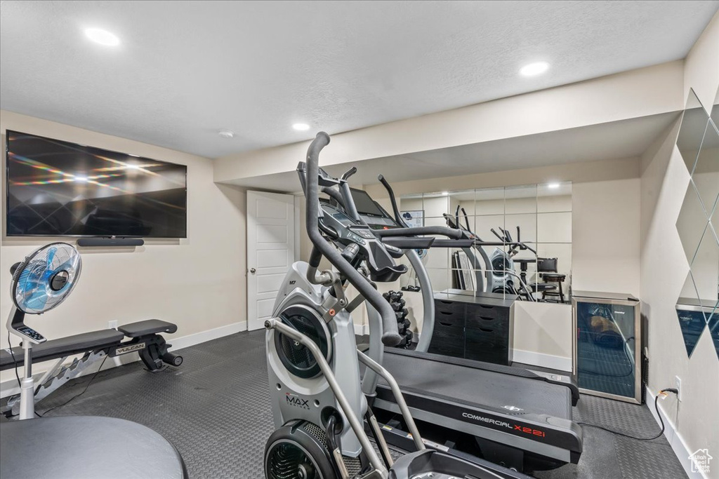 Workout room featuring baseboards and recessed lighting
