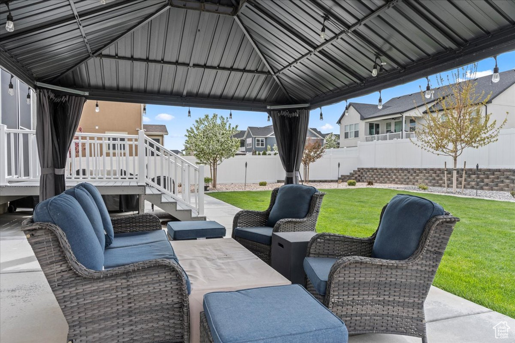 View of patio / terrace with an outdoor living space, a deck, a fenced backyard, a residential view, and stairs
