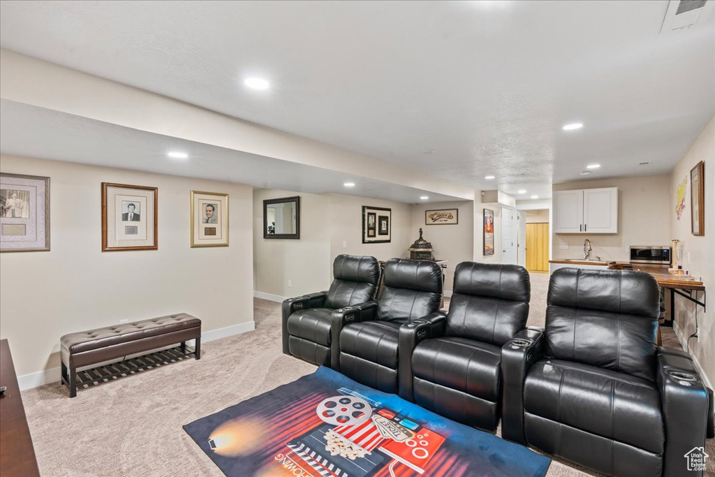 Cinema room featuring baseboards, carpet flooring, visible vents, and recessed lighting