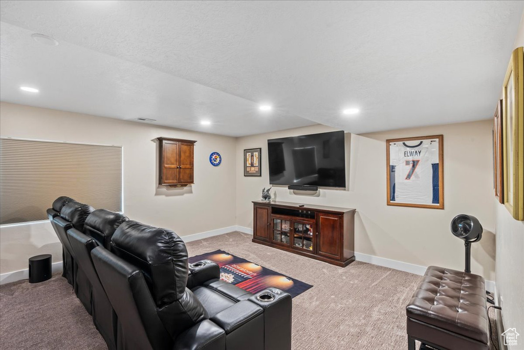 Living room featuring recessed lighting, baseboards, and light colored carpet
