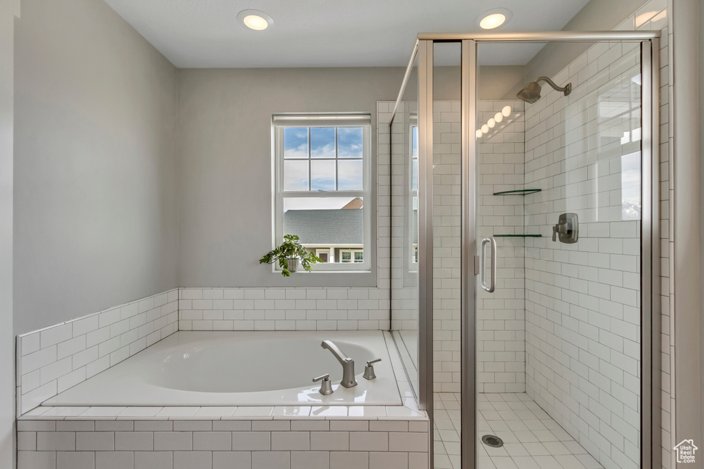 Bathroom featuring a stall shower and a garden tub