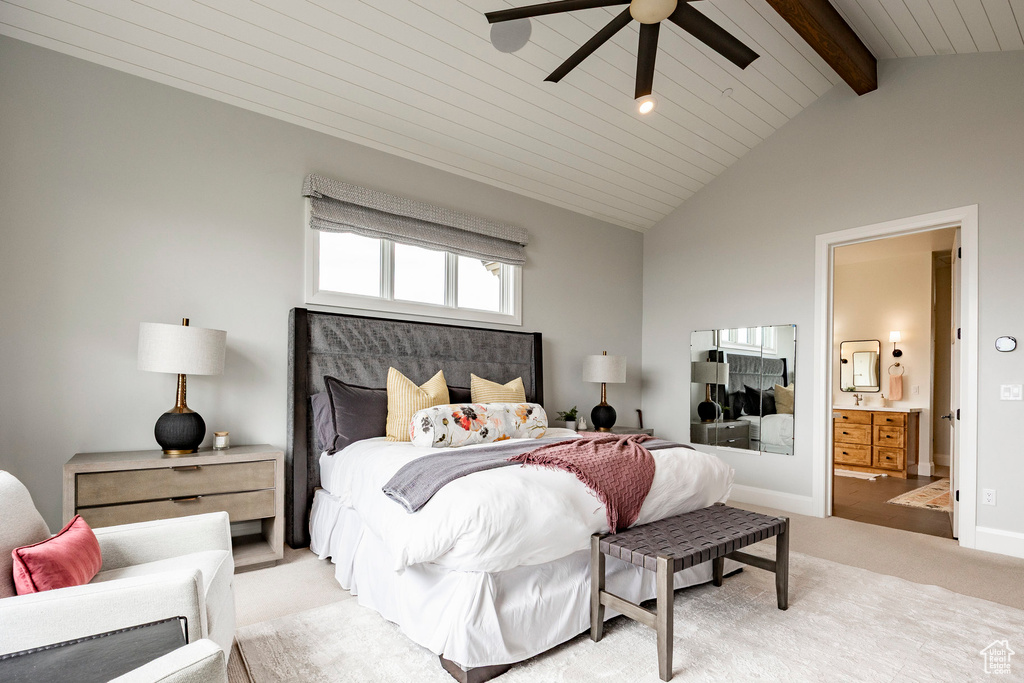 Bedroom featuring light carpet, ensuite bath, ceiling fan, and baseboards