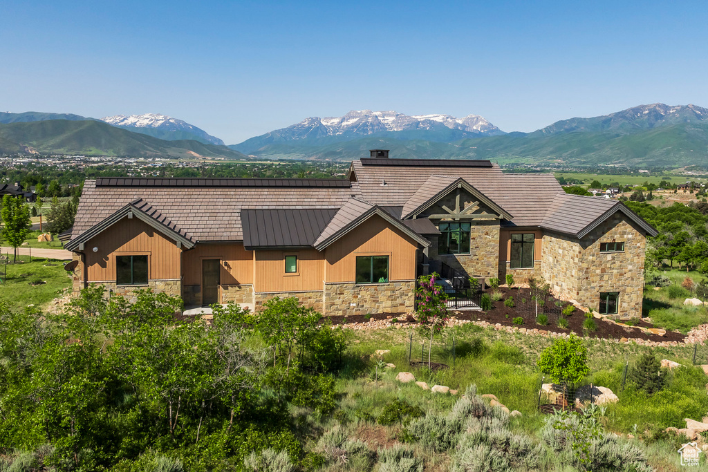 View of front of property featuring stone siding and a mountain view
