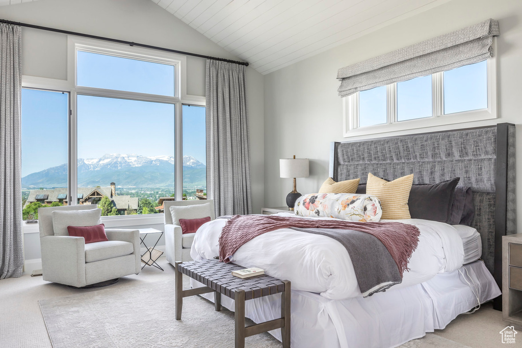 Bedroom featuring a mountain view, lofted ceiling, and carpet floors