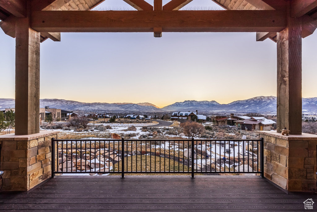 Snow covered deck featuring a mountain view