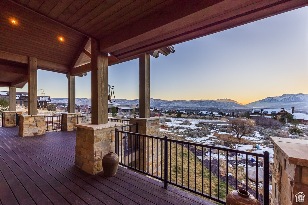Snow covered deck featuring a mountain view