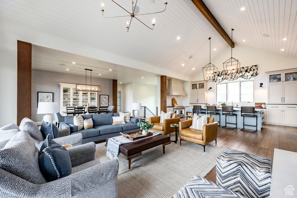 Living area with a chandelier, wood-type flooring, beamed ceiling, high vaulted ceiling, and recessed lighting