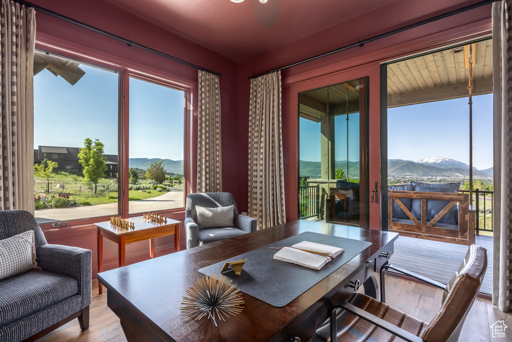 Office area with a mountain view and hardwood / wood-style flooring