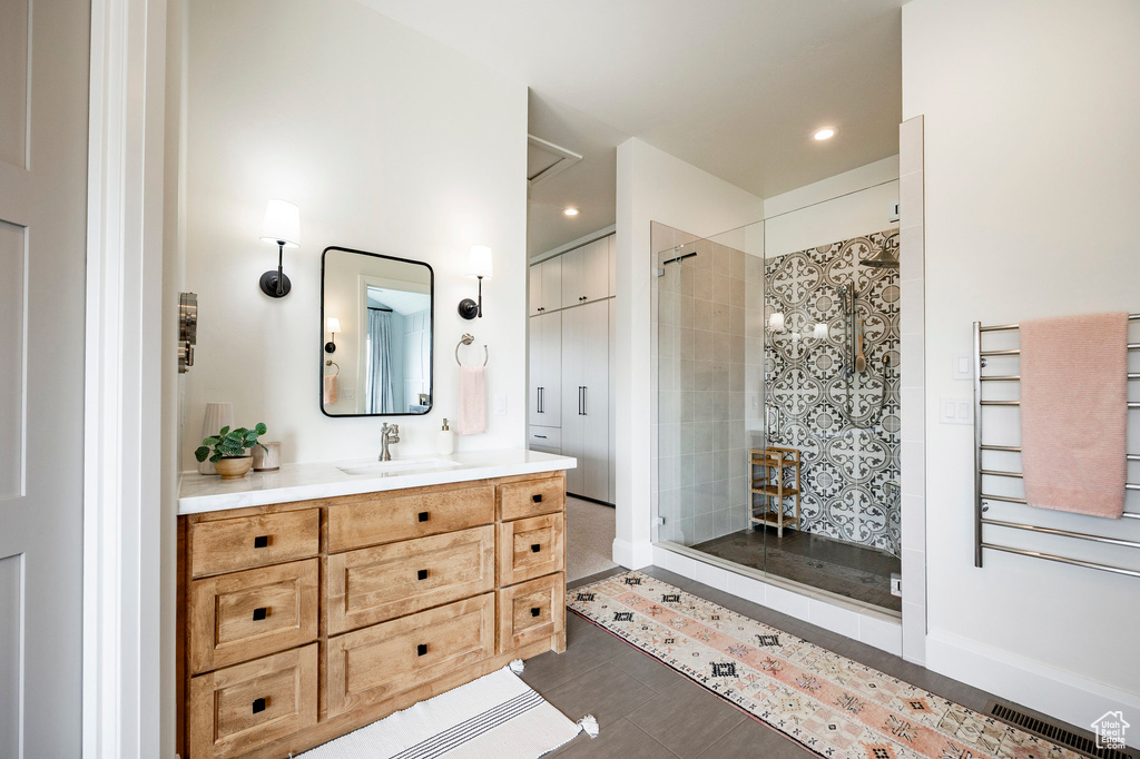 Full bath with vanity, a shower stall, radiator heating unit, and recessed lighting