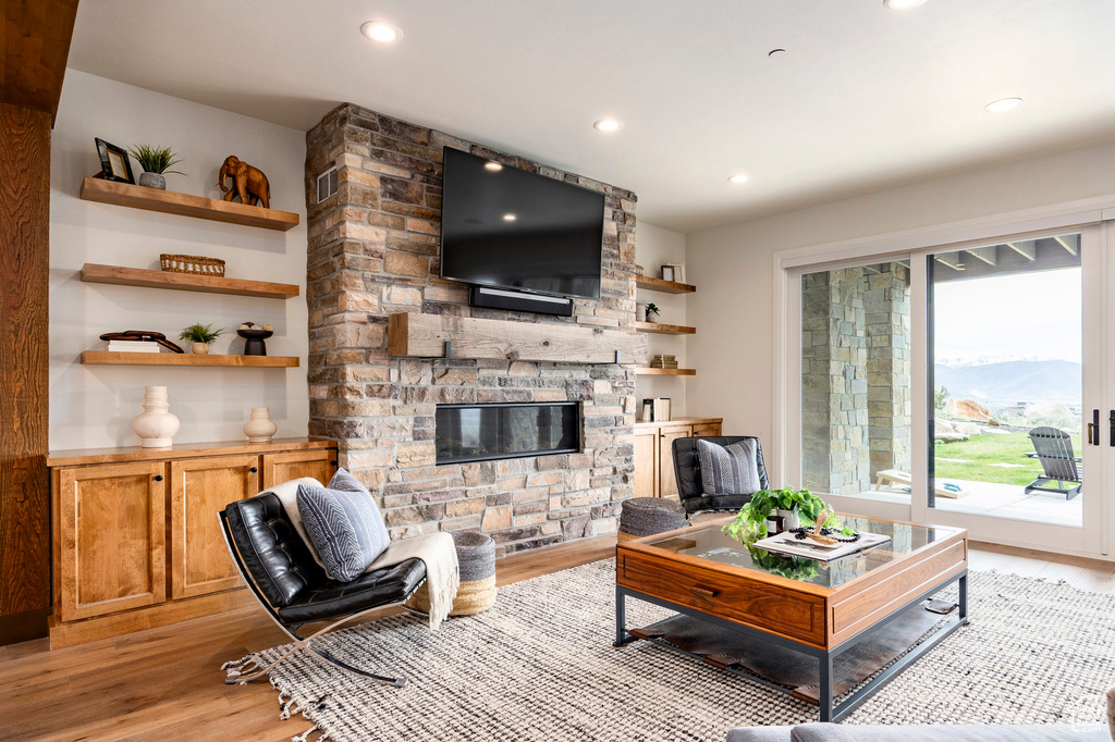 Living room with light wood-style floors, a fireplace, and recessed lighting