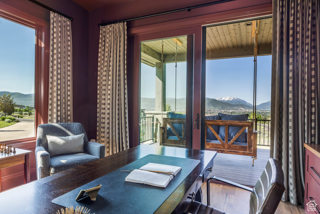 Office featuring a mountain view, healthy amount of natural light, and wood finished floors
