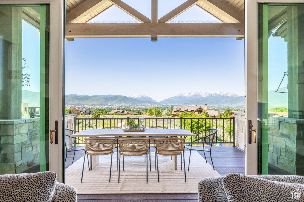Balcony featuring a mountain view and outdoor dining area