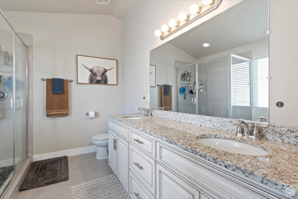 Bathroom with a sink, toilet, and a shower stall
