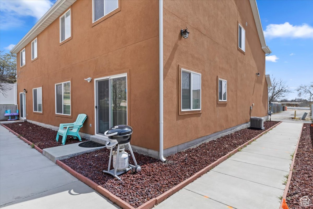 View of side of home with cooling unit