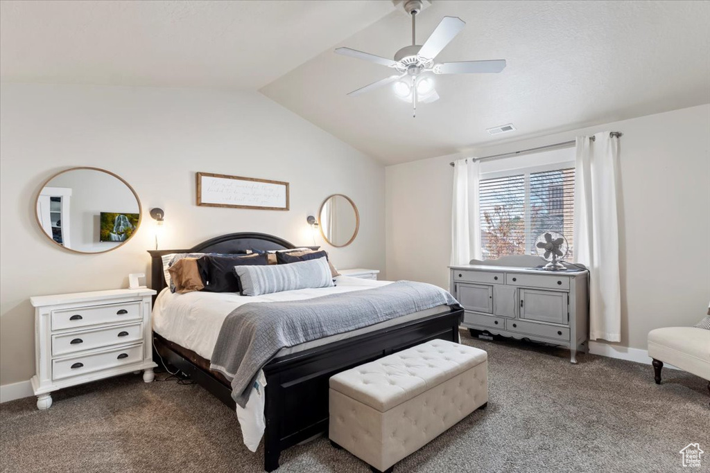 Bedroom featuring ceiling fan, visible vents, carpet floors, lofted ceiling, and baseboards