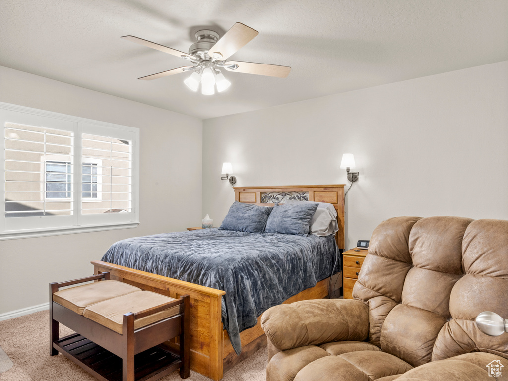 Bedroom featuring ceiling fan, carpet, and baseboards