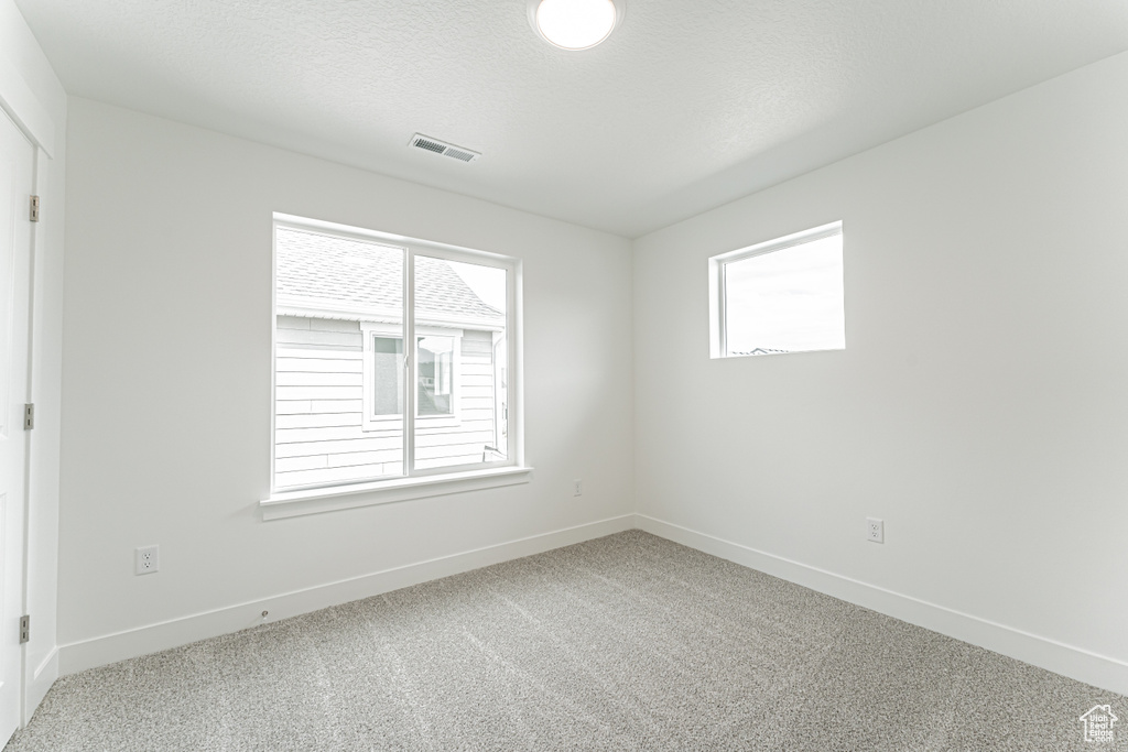 Spare room with carpet floors and baseboards