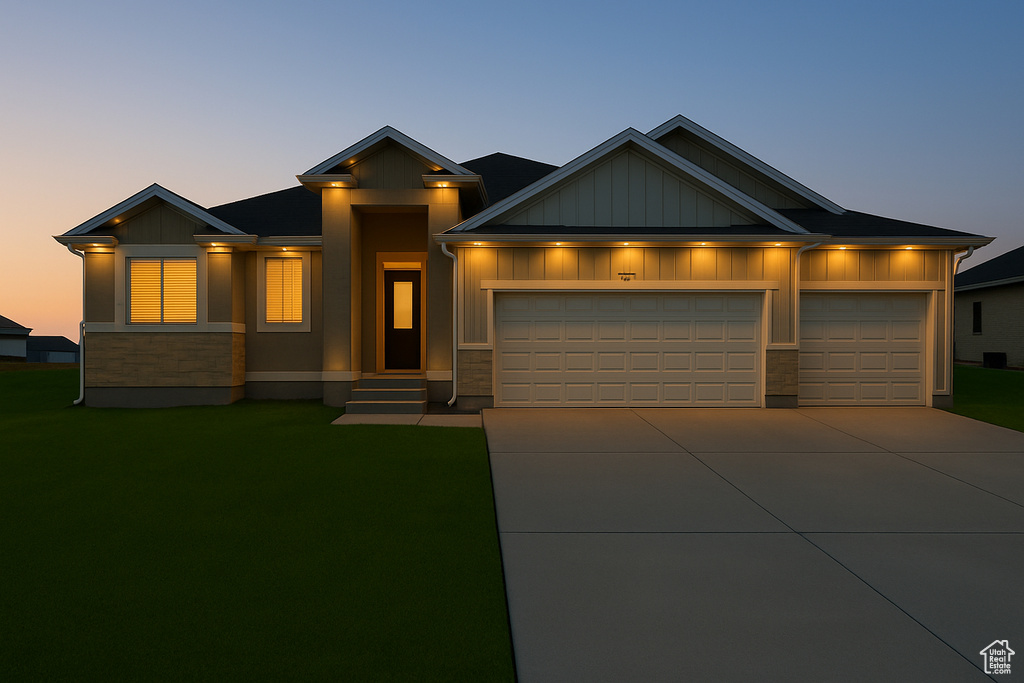 View of front of home featuring an attached garage, a front lawn, and board and batten siding