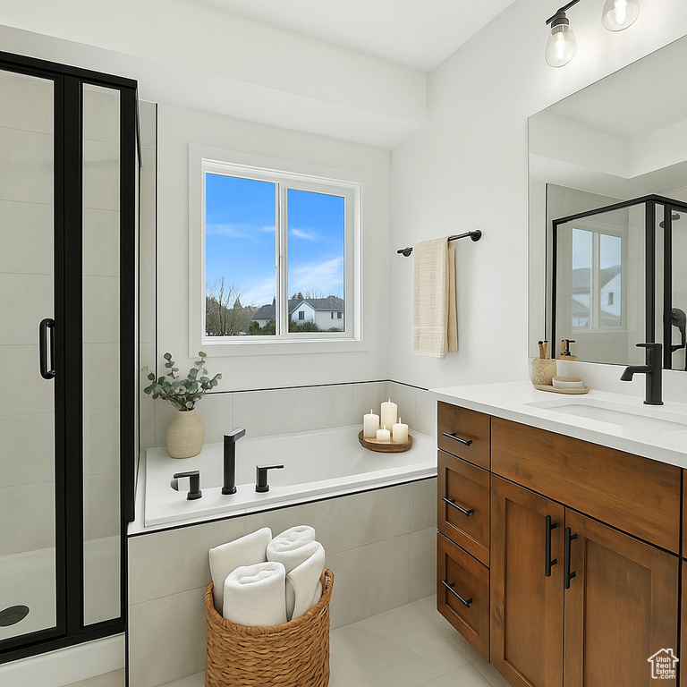 Bathroom featuring vanity, a stall shower, and a garden tub
