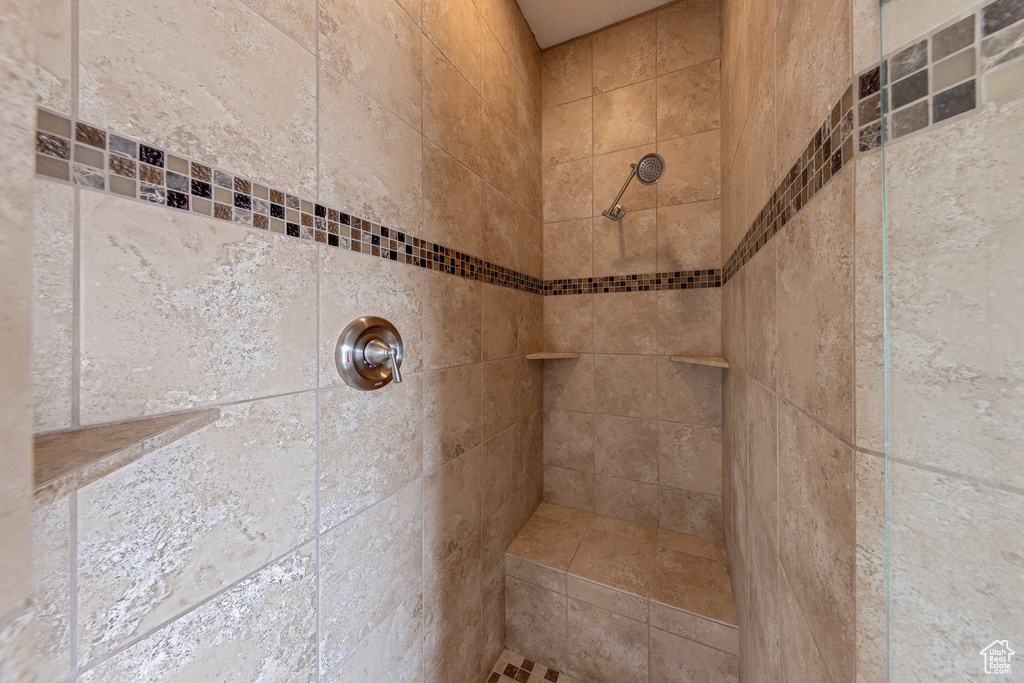 Full bath featuring a tile shower
