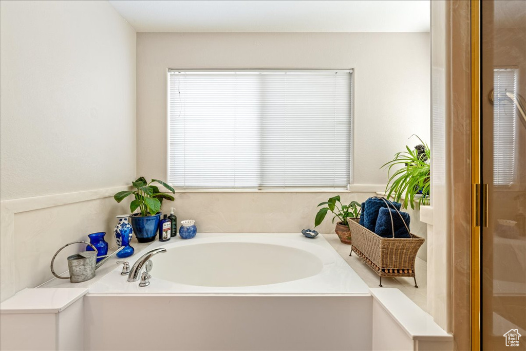 Bathroom featuring a bath and plenty of natural light