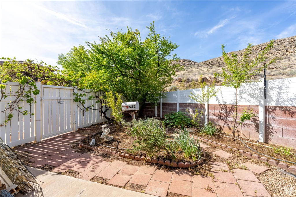 View of patio with fence and a gate