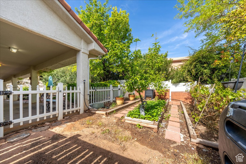 View of yard with a garden and fence
