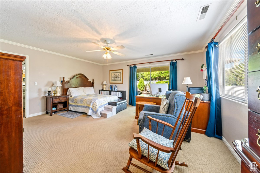 Bedroom with visible vents, baseboards, ornamental molding, and carpet floors