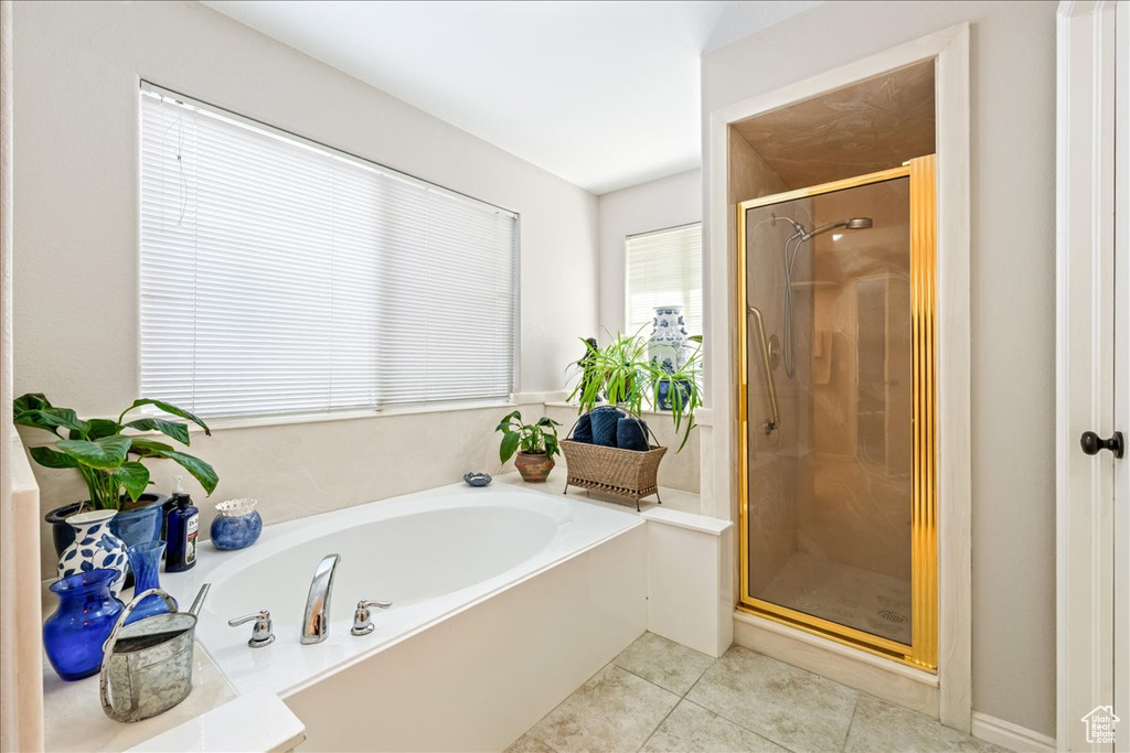 Full bath with a bath, tile patterned flooring, and a stall shower