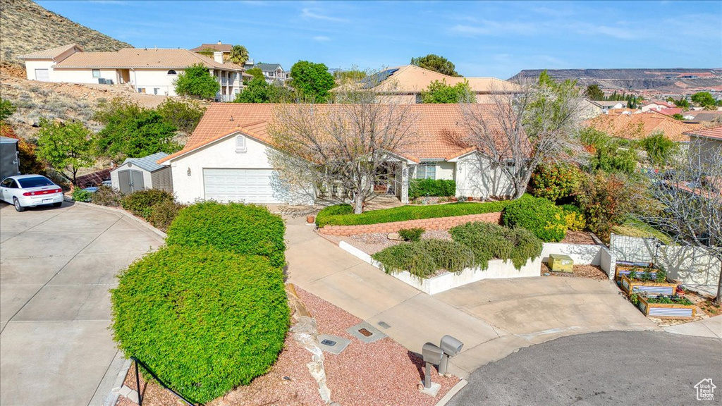 View of front of home with concrete driveway and a residential view