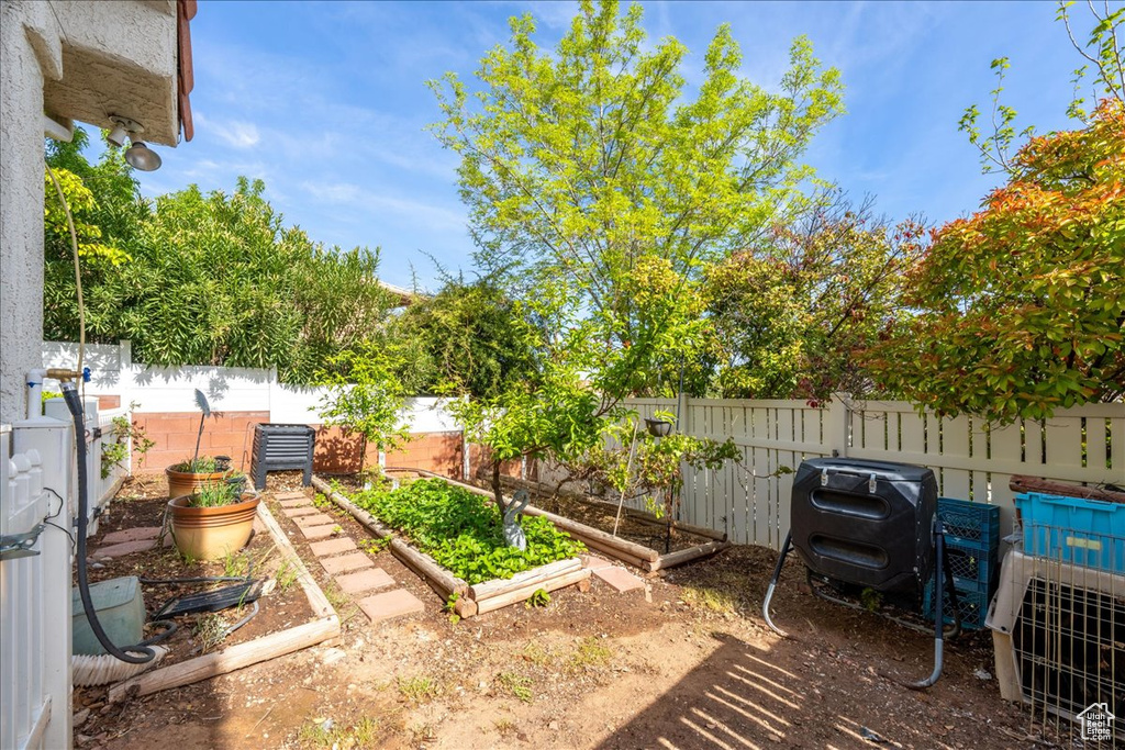 View of yard featuring a garden and a fenced backyard