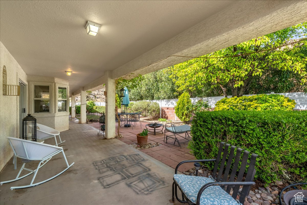 View of patio / terrace with fence and a fire pit