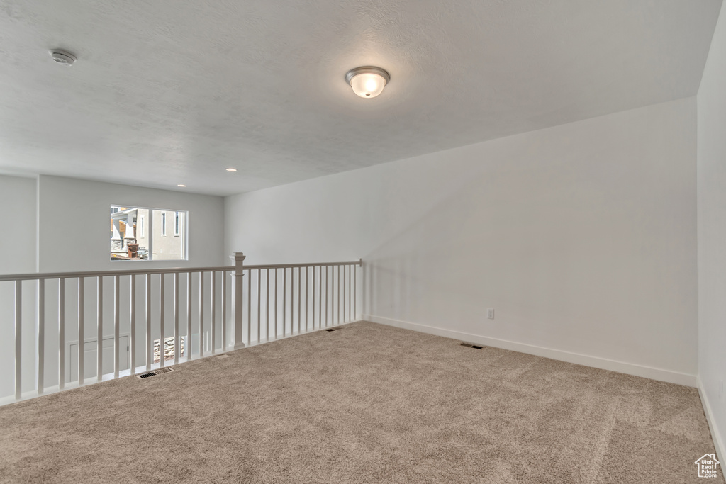 Spare room with baseboards, carpet flooring, and visible vents