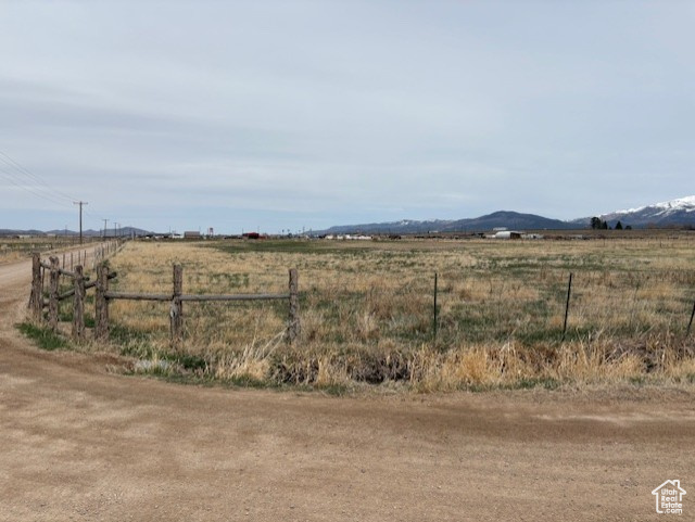 View of yard featuring a rural view and fence