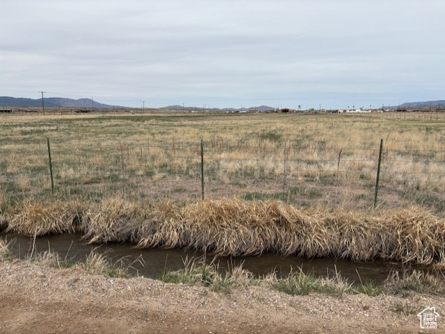 Exterior space featuring a rural view and fence
