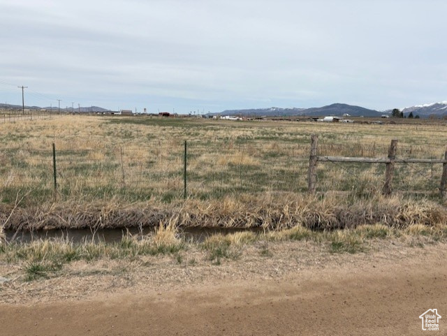 View of yard featuring a rural view and fence