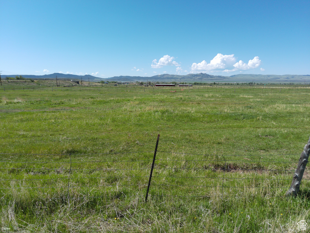 View of mountain backdrop with rural landscape and a pastoral area