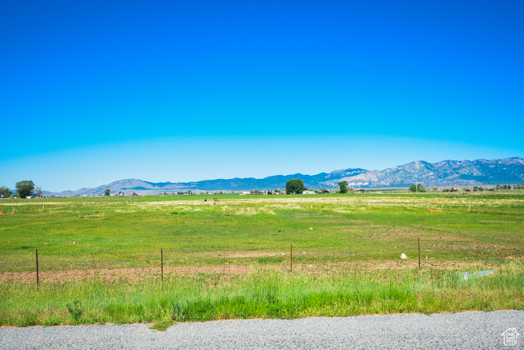 View of mountain background with rural landscape and agricultural land