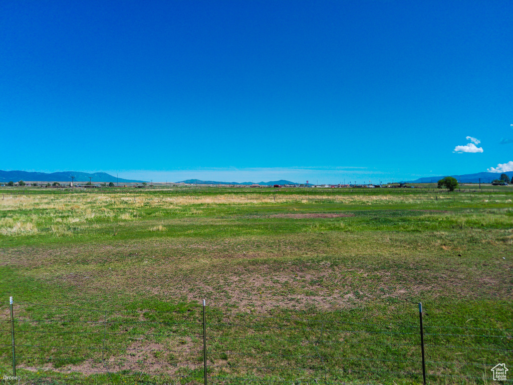 View of yard featuring a view of countryside and a mountain view